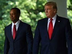 US President Donald Trump and professional golfer Tiger Woods walk to a Presidential Medal of Freedom ceremony in the Rose Garden of the White House on May 6, 2019, in Washington, DC.