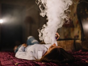 Girl smoking in bed.