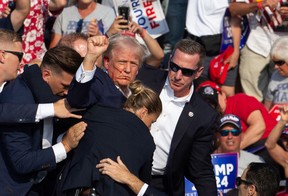 Republican candidate Donald Trump is seen with blood on his face surrounded by secret service agents as he is taken off the stage at a campaign event at Butler Farm Show Inc. in Butler, Pennsylvania, July 13, 2024. (Photo by REBECCA DROKE/AFP via Getty Images)