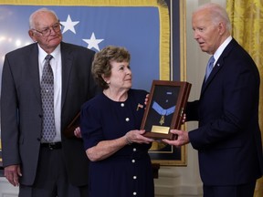 U.S. President Joe Biden presents the Medal of Honor to Theresa Chandler, great great-granddaughter of Private George D. Wilson, as Gerald Taylor, great great-nephew of Private Philip G. Shadrach, looks on during a ceremony in the East Room of the White House in Washington, D,C., Wednesday, July 3, 2024.