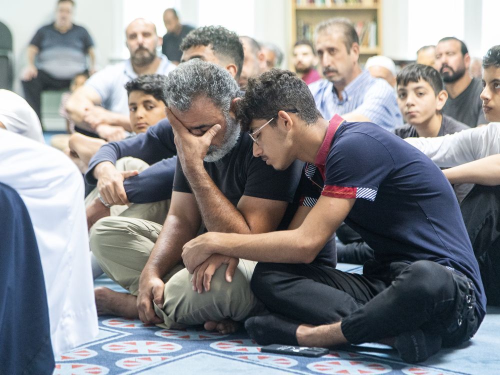 Lami Buz and his 17-year-old son Mohamad grieve during the funeral for their son and brother, 14-year-old Omer, who drowned at Port Stanley days earlier. Photo taken at the London Muslim Mosque on Wednesday July 17, 2024. Derek Ruttan/ The London Free Press
