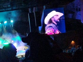 Singer Ian Munsick is shown on a videoboard