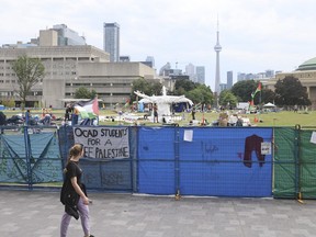 Protesters at the University of Toronto pro-Palestinian encampment move their tents and valuables.