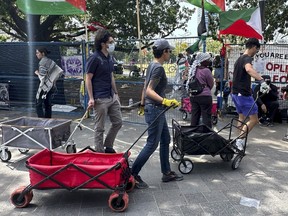 Protesters at the University of Toronto pro-Palestinian encampment move their tents and valuables.