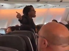 Screenshot of Air Canada flight attendant losing it on passenger.