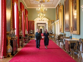 Staff members make final preparations in the East Wing's principal corridor, which measures 240 feet and spans the width of the palace. It is furnished with paintings, porcelain and furniture from the Royal Collection.