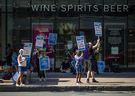 LCBO workers on strike outside of the LCBO location along Queens Quay E. in downtown Toronto on Friday, July 12, 2024.