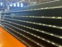 Empty shelves are seen in an alcohol aisle at a Loblaws store.