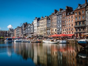 In bygone days, Honfleur was one of France's most important trading ports. Today the pretty town is popular with tourists who come to stroll the cobblestoned streets, see the ancient buildings and old basin, and sample local seafood. PHOTO: VALENTIN PACAUT/THE EXPLORERS