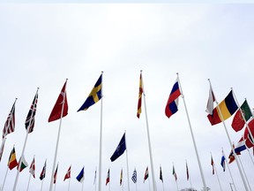 Prime Minister Justin Trudeau is heading to Washington, D.C., next week to take part in the NATO leaders' summit. The flag of Sweden, center left, flaps in the wind alongside other alliance member flags after a ceremony to mark the accession of Sweden to NATO at NATO headquarters in Brussels, Monday, March 11, 2024.