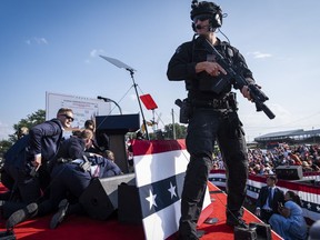 U.S. Secret Service agents and counter assault team members respond after shots were fired toward former president Donald Trump on Saturday at a rally in Butler, Pa.