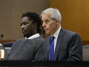 Young Thug, whose real name is Jeffery Lamar Williams, and his lawyer, Brian Steel, watch Judge Ural Glanville speak during the hearing of key witness Kenneth Copeland at the Fulton County Superior Court in Atlanta on June 10, 2024. The judge overseeing the racketeering and gang prosecution against Young Thug and others on Monday, July 1, 2024 put the long-running trial on hold until another judge rules on requests by several defendants that he step aside from the case.