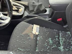 An evidence marker sits in a grey Kia Soul that had its driver-side window shot out during a shooting in North York on Tuesday, Aug. 27, 2024.