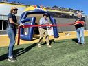 El ex jugador de la Liga Canadiense de Fútbol Stu Lang corta la cinta durante la inauguración oficial del Pabellón Lang en el Estadio Richardson en Kingston el año pasado.