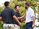 Tom Kim of the International team and Scottie Scheffler of the U.S. team shake hands after Scheffler and Russell Henley defeated Kim and Sungjae Im 3-and-2 during Thursday's four-ball matches on Day 1 of the 2024 Presidents Cup at The Royal Montreal Golf Club on Thursday, Sept. 26, 2024, in Montreal.