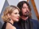 Musician Dave Grohl (R) and Jordyn Blum attend the 88th Annual Academy Awards at Hollywood & Highland Center on February 28, 2016 in Hollywood, California.