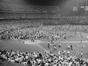 Fans pour onto the field at the Oakland Coliseum after the Oakland A's beat the Los Angeles Dodgers 3-2 and won their third straight World Series, Oct. 17, 1974, in Oakland. (AP File)