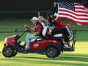 U.S. Team Captain Jim Furyk drives a cart with a U.S. flag during the 2024 Presidents Cup at the Royal Montreal Golf Club on September 29, 2024 in Montreal.