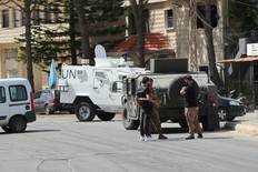 A UN vehicle and Lebanese army forces are seen standing guard near the site of a controlled explosion after a communication device found on the ground in southern Lebanon, between the villages of Burj al Muluk and Klayaa, on Sept. 19, 2024.