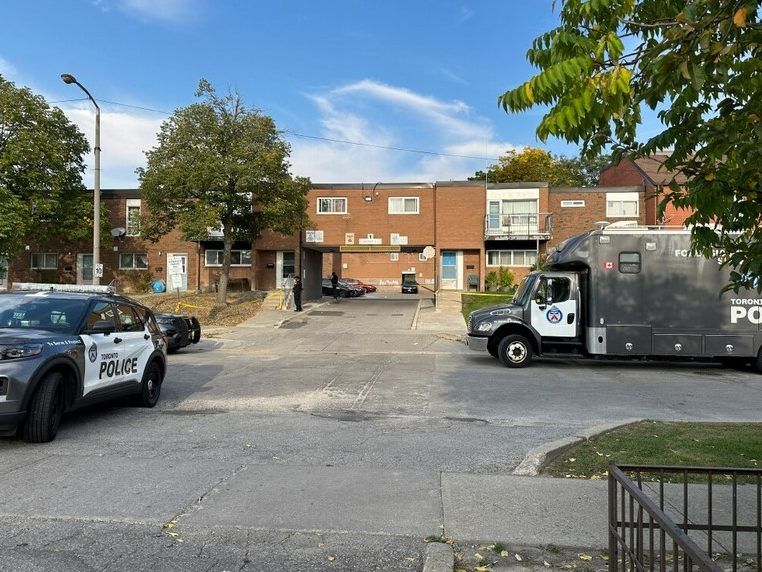 Two men died in a brazen daylight shooting at a townhouse complex Tuesday in the Driftwood Ave.-Jane St. area.