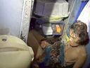 In this photo provided by Kunyakit Thanawtchaikun, a python coils itself around Arom Arunro's torso, squeezing her down to the floor of her kitchen in Samut Prakan province, Thailand, Tuesday, Sept. 17, 2024.