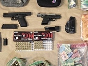 Weapons, ammunition, drugs and cash seized by Toronto Police.