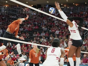 A player blocks a shot during a NCAA women's volleyball match. A player blocks a shot during a NCAA women's volleyball match.