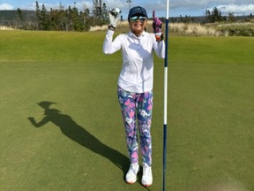 Linda Rindt poses with her hole-in-one ball after acing the eighth hole at The Nest during the 100 Hole Hike at Cabot Cape Breton.