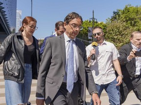 Dr. Mark Chavez, a physician from San Diego, who is charged in connection with Matthew Perry's fatal overdose, centre, walks out of the United States Courthouse after pleading guilty to conspiring to distribute the surgical anesthetic ketamine in Los Angeles on Wednesday, Oct. 2, 2024.