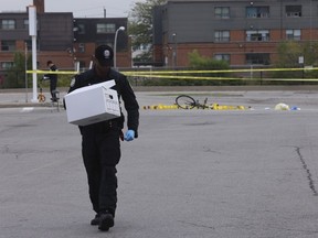 Toronto Police forensic officers pick up evidence.