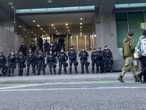 Toronto Police officers stand guard outside the Consulate of Israel at Yonge and Bloor Sts. in downtown Toronto, Saturday, Oct. 5, 2024.