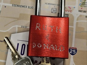 An engraved lock waits to be attached to the love lock sculpture outside the visitors centre in Loveland, Colo.