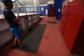 Arena manager Mike Pisano stands on one of the rubber tiles covering worn-out sections of the floor at Moss Park Arena in June 2024