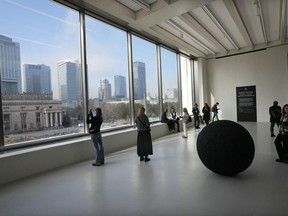 People look out of the window of the Museum of Modern Art in Warsaw, Poland, on Thursday Oct. 24, 2024.