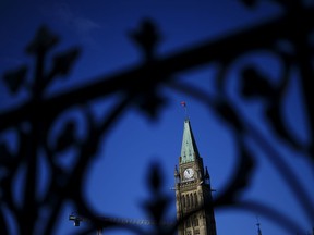 The Federal Court will soon decide whether or not a $2.5-billion class action lawsuit against Canada for its discrimination against Black public servants can proceed. The Peace Tower is framed through the iron railing on Parliament Hill in Ottawa on October 24, 2024.