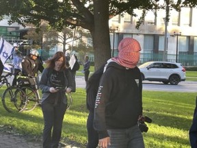 Many of the anti-Israel protesters at Queen’s Park Monday hid their faces under their scarves. JOE WARMINGTON/TORONTO SUN