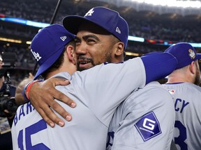 Austin Barnes #15 and Teoscar Hernández #37 of the Los Angeles Dodgers celebrate after defeating the New York Yankees 7-6 in Game Five to win the 2024 World Series at Yankee Stadium on October 30, 2024 in the Bronx borough of New York City.