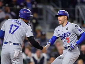 Freddie Freeman #5 of the Los Angeles Dodgers celebrates with teammate Shohei Ohtani #17 after hitting a two-run home run against the New York Yankees in the first inning during Game Three of the 2024 World Series at Yankee Stadium on October 28, 2024 in the Bronx borough of New York City.