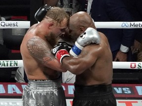 Jake Paul (left) and Mike Tyson hug at the end of their heavyweight boxing bout.