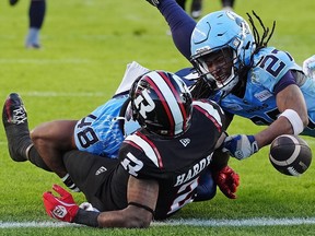 Ottawa Redblacks wide receiver Justin Hardy (2) is tackled short of the endzone by Toronto Argonauts linebacker Wynton McManis (48) and defensive back Mark Milton (27) during second half Eastern Conference semifinal CFL football action in Toronto on Saturday, November 2, 2024. THE CANADIAN PRESS/Frank Gunn