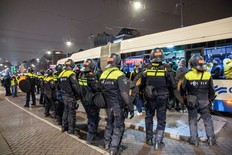 Dutch mobile police officers stand guard after several scuffles broke out in the city centre following the Europa League match between Ajax Amsterdam and Maccabi Tel Aviv, in Amsterdam on Nov. 8, 2024.