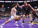 Pistons point guard Cade Cunningham (left) drives to the basket against Raptors centre Jakob Poeltl (right) during the Emirates NBA Cup game at Scotiabank Arena in Toronto, Friday, Nov. 15, 2024.