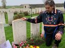 Rick Decoteau of Fraser Lake, British Columbia, visits the grave of his great-uncle Alex Decoteau for the first time at the Passchendaele New British Cemetery in Zonnebeke, Belgium, where 650 Canadian soldiers killed in the First World War are buried, on First Nations Veterans Day on Friday, November 8, 2024.