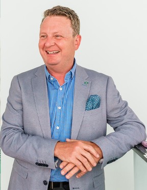 smiling man, grey jacket, blue shirt