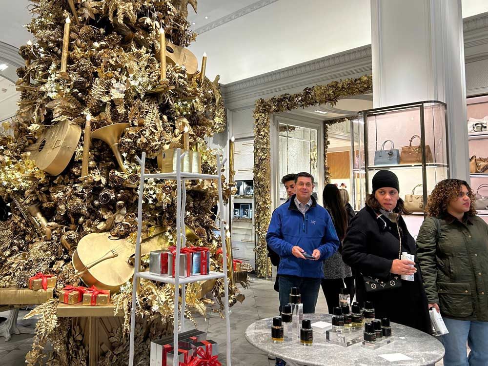 Shoppers pass a Christmas tree at the Bergdorf Goodman store on Sunday, Nov. 24, 2024, in New York.