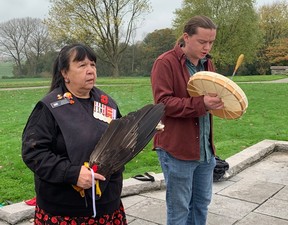 Honorary Capt. Debbie Eisan (R), an elder of the Mi’kmaw Native Friendship Centre and a Royal Canadian Navy performs a smudging ceremony while Mi’kmaw singer Aaron Prosper pays tribute to the fallen with his vocals and drum at Hill 62 in Flanders Fields on on Thursday, Nov. 7, 2024.