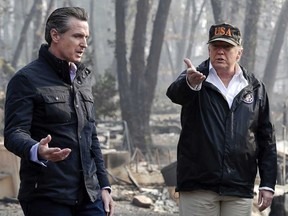 President Donald Trump talks with then California Gov.-elect Gavin Newsom, left, during a visit to a neighbourhood impacted by the wildfires in Paradise, Calif., Nov. 17, 2018.