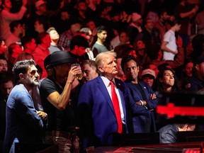U.S. President-elect Donald Trump, singer Kid Rock and entrepreneur Vivek Ramaswa stand up after UFC Heavyweight Champion Jon Jones' TKO victory against challenger Stipe Miocic in the UFC 309 heavyweight title bout at Madison Square Garden in New York, on Nov. 16, 2024.