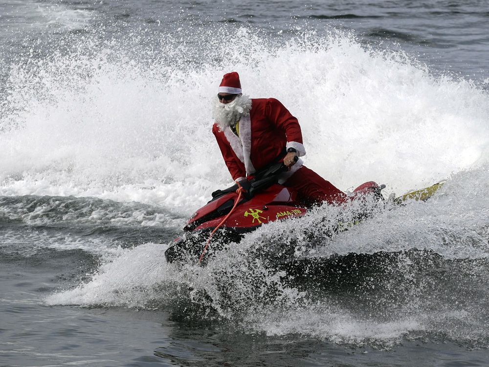 Brazilian Santa swaps sleigh for Jet Ski to deliver toys in Rio ...