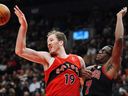 Raptors' Jakob Poeltl (19) and Chicago Bulls' Jalen Smith (7) battle for a rebound during first half NBA basketball action in Toronto on Monday.